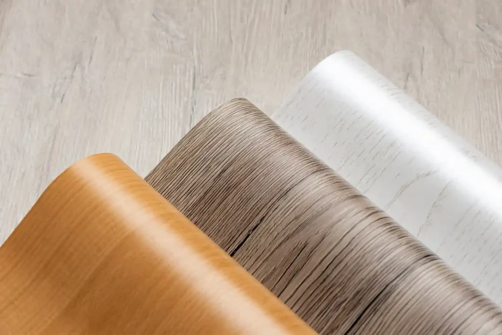 Stylish cushion flooring installation with timber, herringbone, and stone effect designs for modern interiors